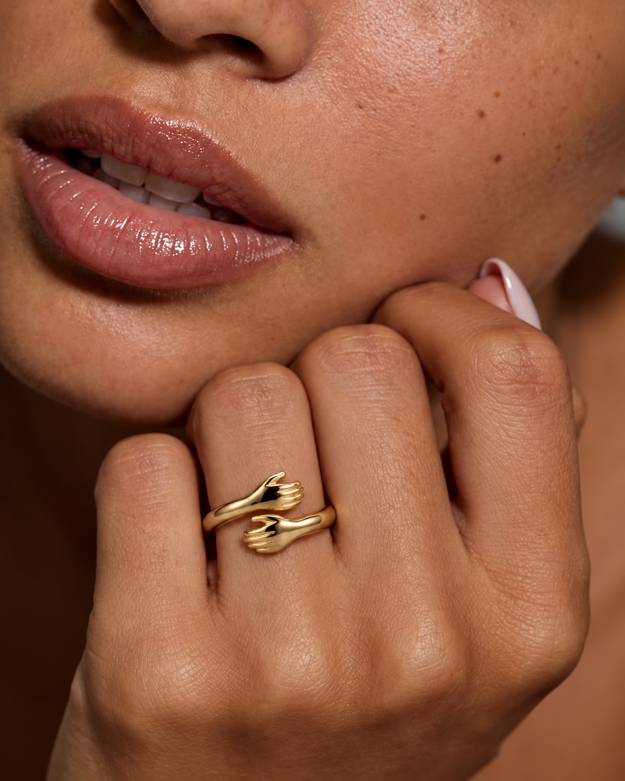 Gold Hug Ring worn on a hand by the face — campaign photo edit