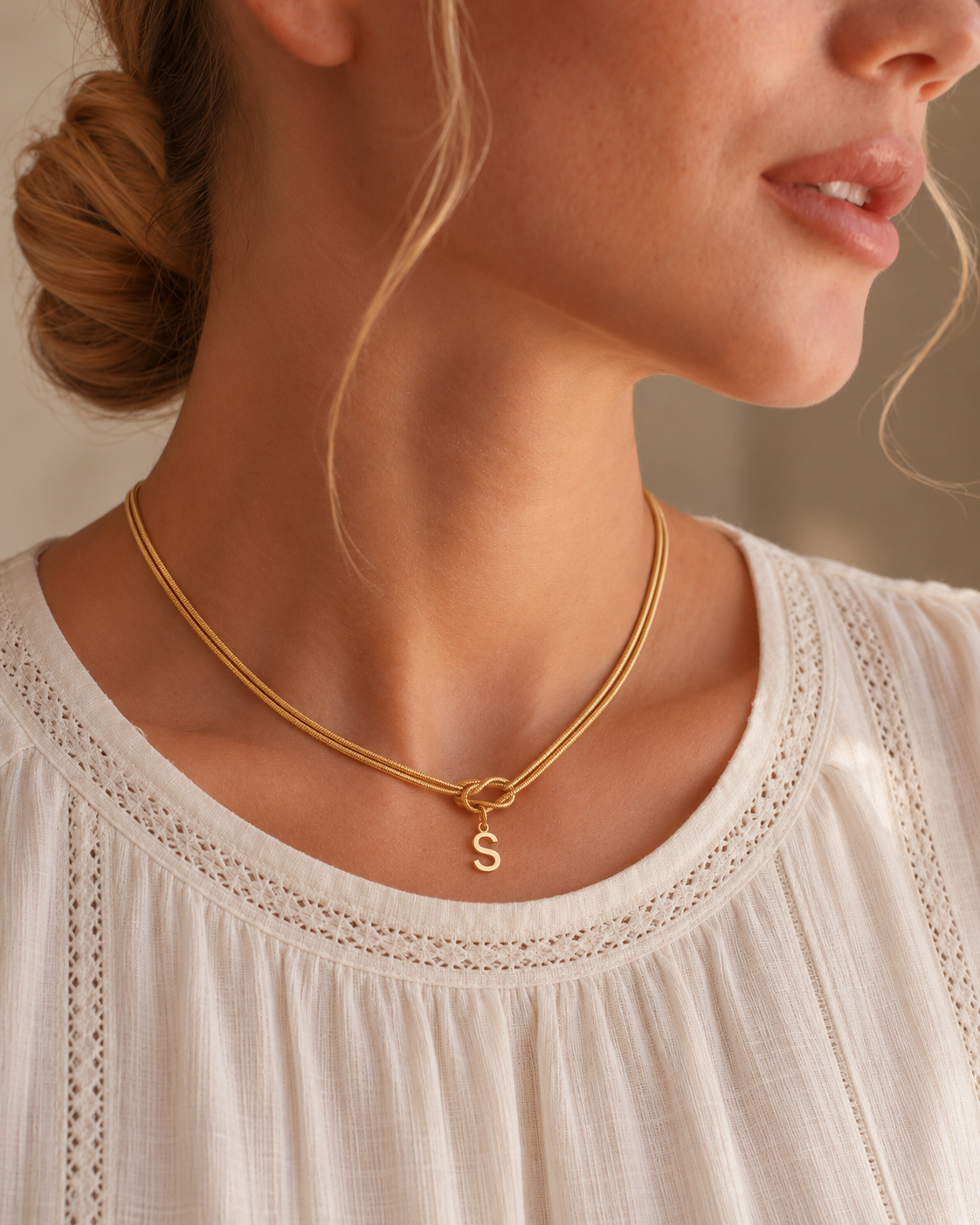lia initial knot necklace — editorial photograph, exact catalogue design