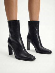 Black high-heel ankle boot with a sleek square toe, smooth leather-look finish, structured shaft, and slim stiletto heel.

