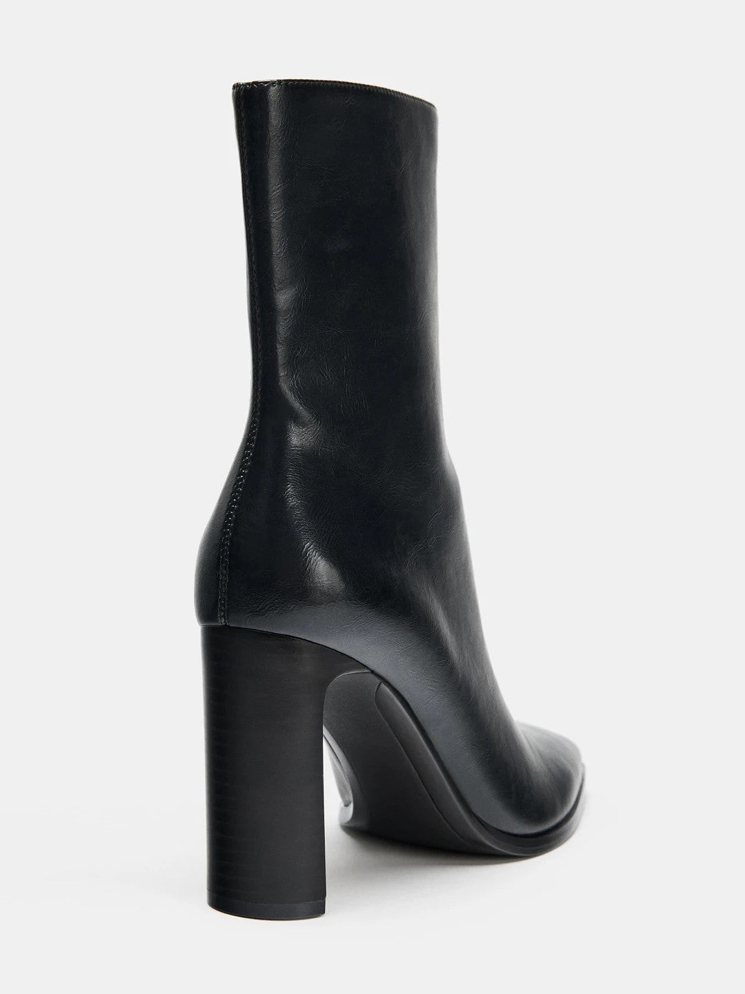 Black high-heel ankle boot with a sleek square toe, smooth leather-look finish, structured shaft, and slim stiletto heel.
