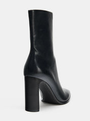 Black high-heel ankle boot with a sleek square toe, smooth leather-look finish, structured shaft, and slim stiletto heel.

