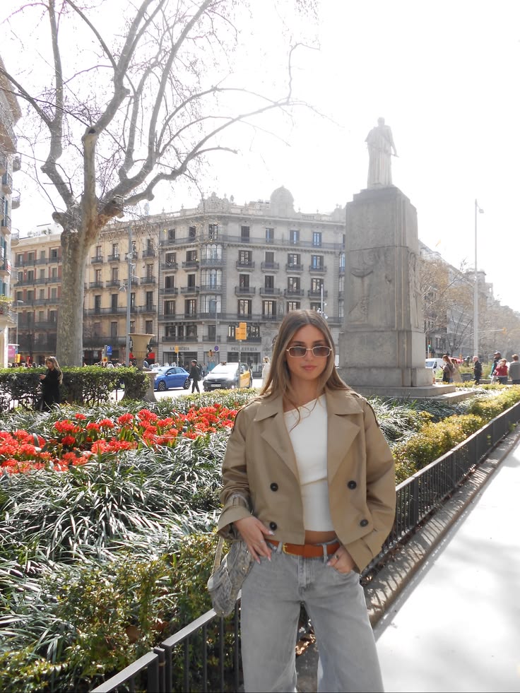 Cropped beige trench jacket worn buttoned